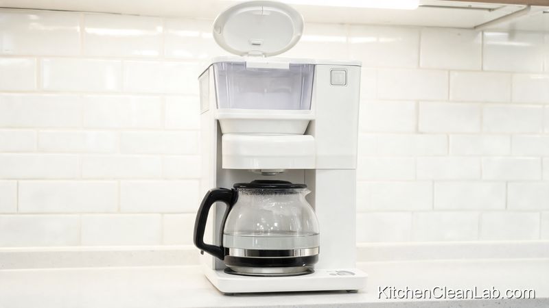 White vinegar and water mixture being used to deodorize and descale a coffee maker