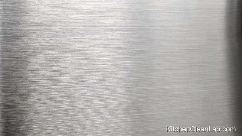 Close-up of stainless steel refrigerator grain direction for streak-free polishing